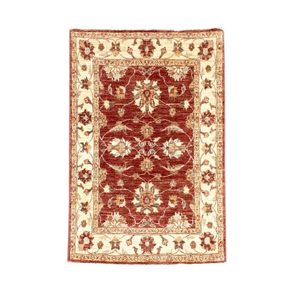 Full view of Afghan Chobi hand-knotted wool rug with deep rust-red floral field and broad ivory border, 133 x 85 cm