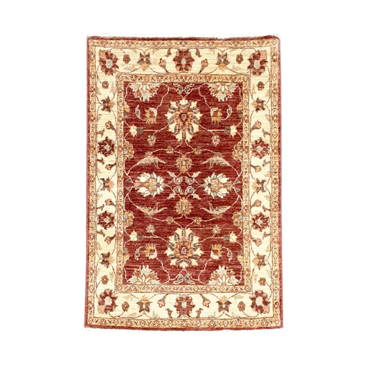 Full view of Afghan Chobi hand-knotted wool rug with deep rust-red floral field and broad ivory border, 133 x 85 cm