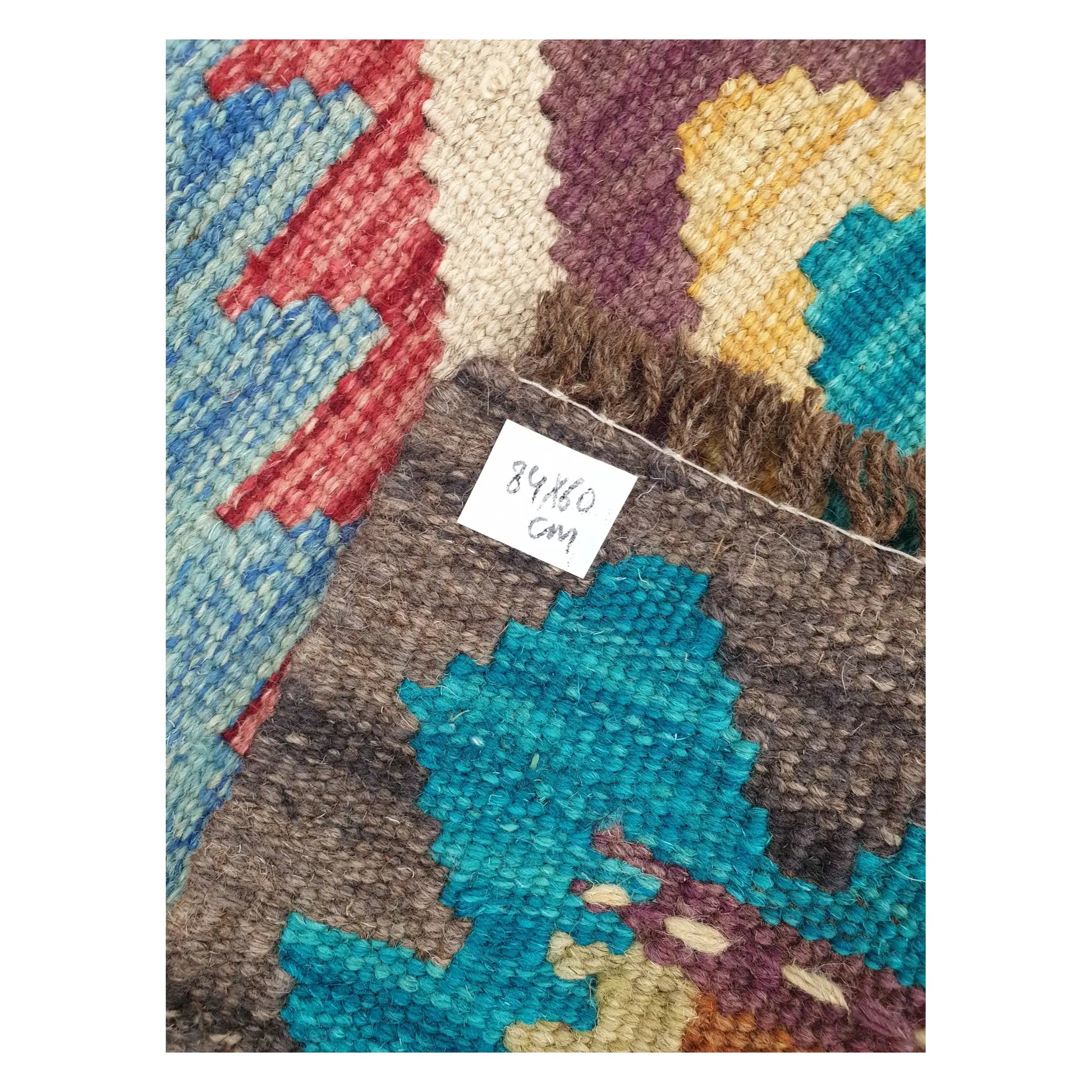 Close-up of Afghan Chobi Kilim wool flatweave texture, fringe, and geometric colour detail, 84 x 60 cm