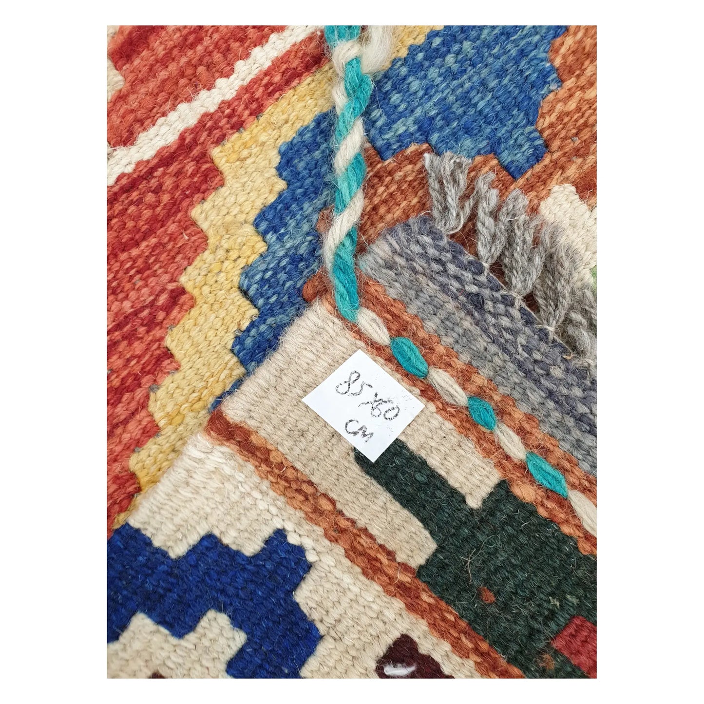 Close-up of Afghan Chobi Kilim wool flatweave texture, fringe, and geometric colour detail, 85 x 60 cm