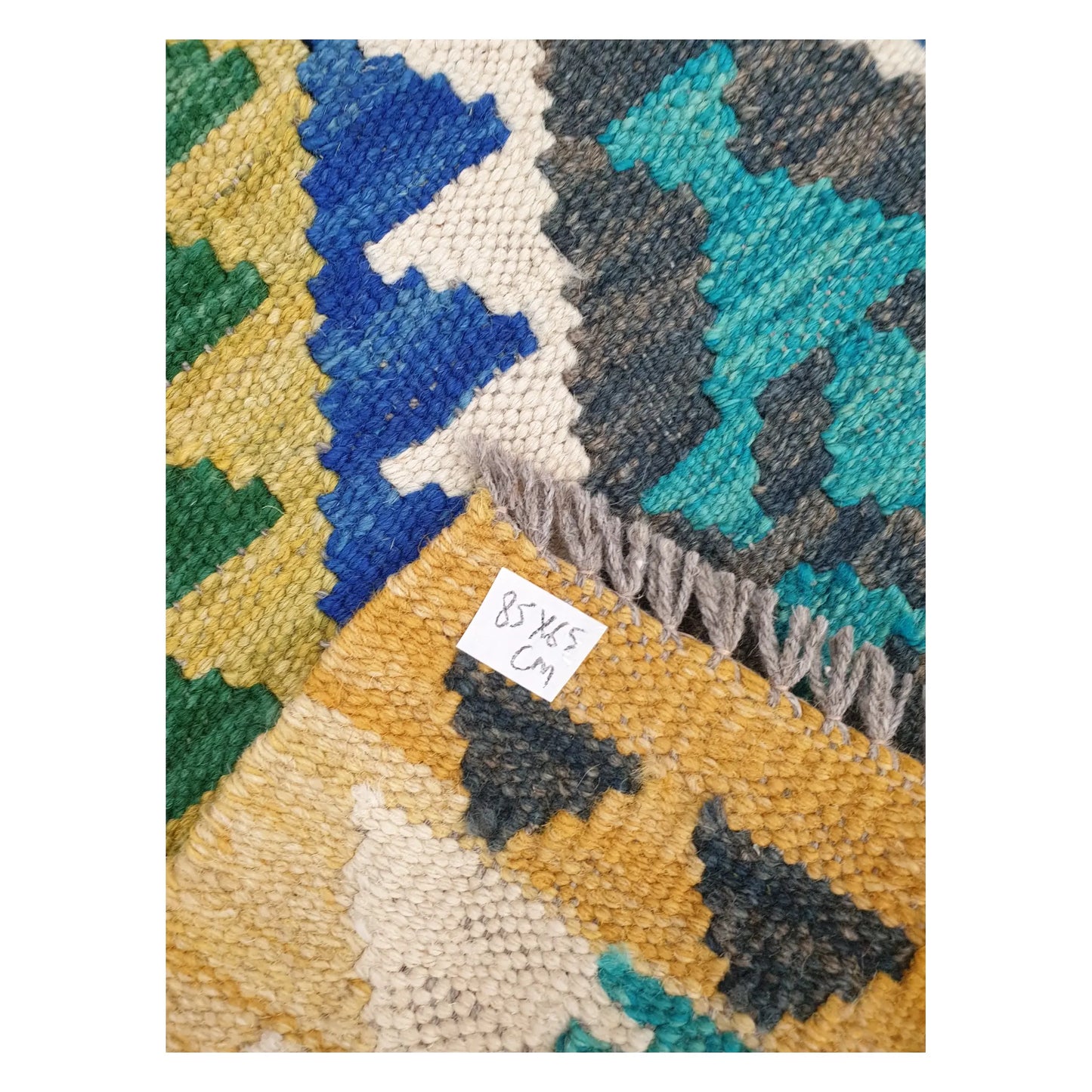 Close-up of Afghan Chobi Kilim wool flatweave texture, fringe, and geometric colour detail, 85 x 65 cm