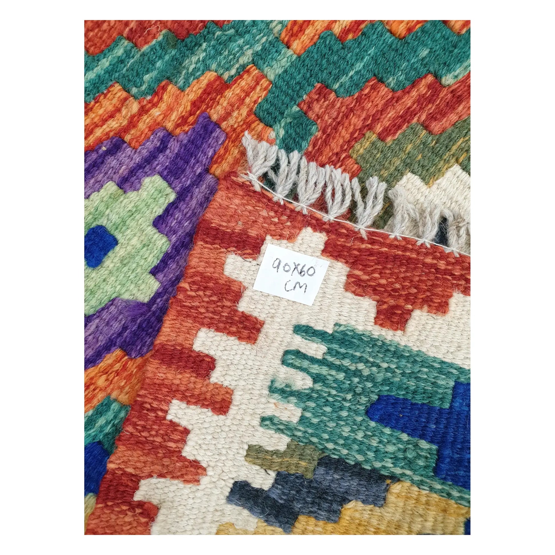 Close-up of Afghan Chobi Kilim wool flatweave texture, fringe, and geometric colour detail, 90 x 60 cm