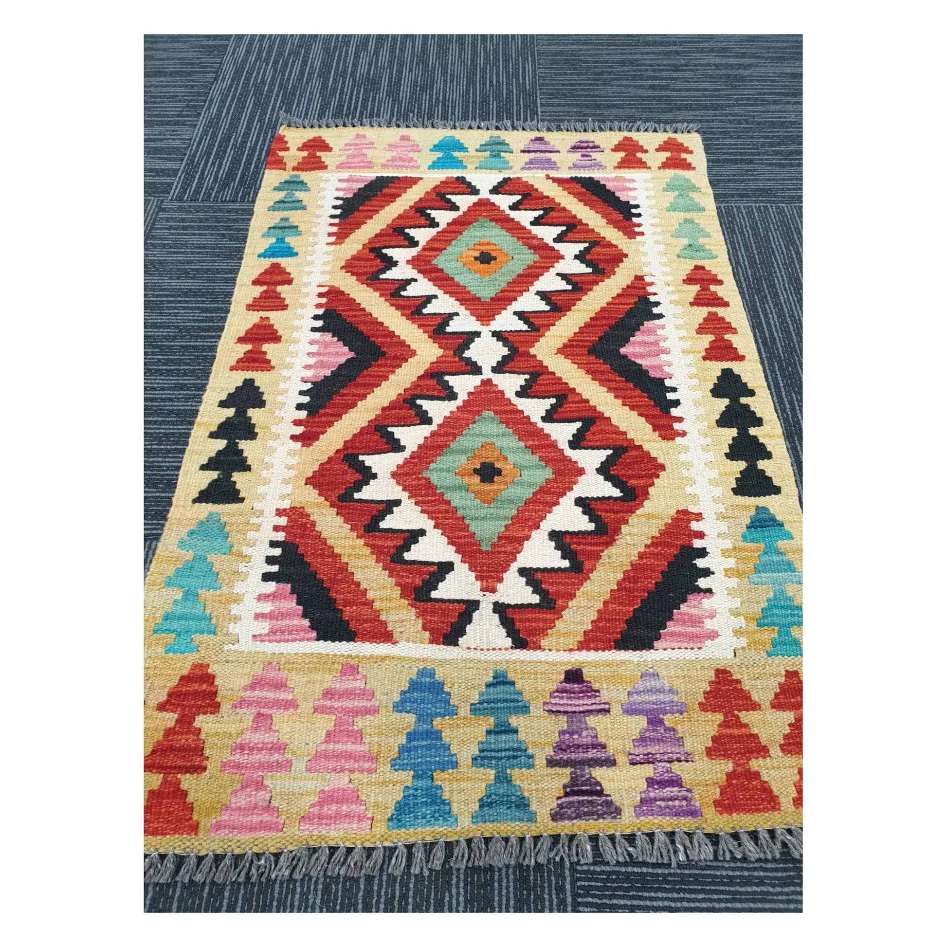 Angled view of Afghan Chobi Kilim flatweave rug showing geometric twin diamond pattern, 91 x 60 cm