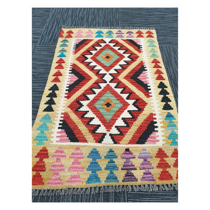 Angled view of Afghan Chobi Kilim flatweave rug showing geometric twin diamond pattern, 91 x 60 cm