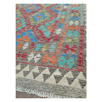 Border detail of Afghan Chobi Kilim blue medallion rug showing rust orange and ivory motifs