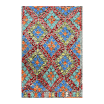 Field detail of Afghan Chobi Kilim rug showing rust-red diamond outlines around blue, turquoise, orange and olive geometric motifs.