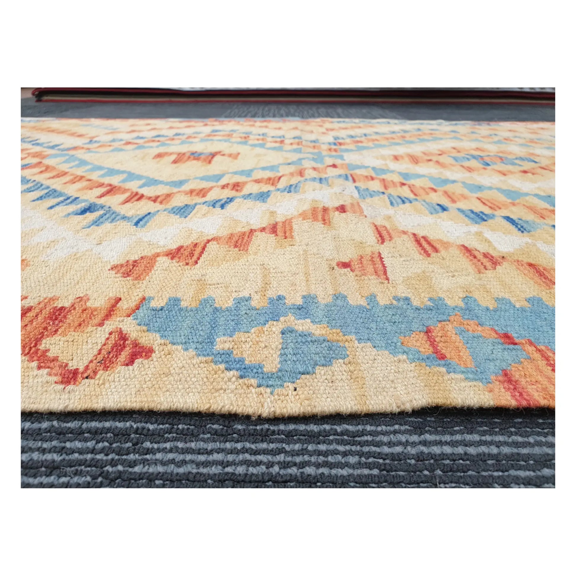 Low-angle close-up of Afghan Chobi Kilim showing wool flatweave texture and geometric pattern detail, 188 x 103 cm