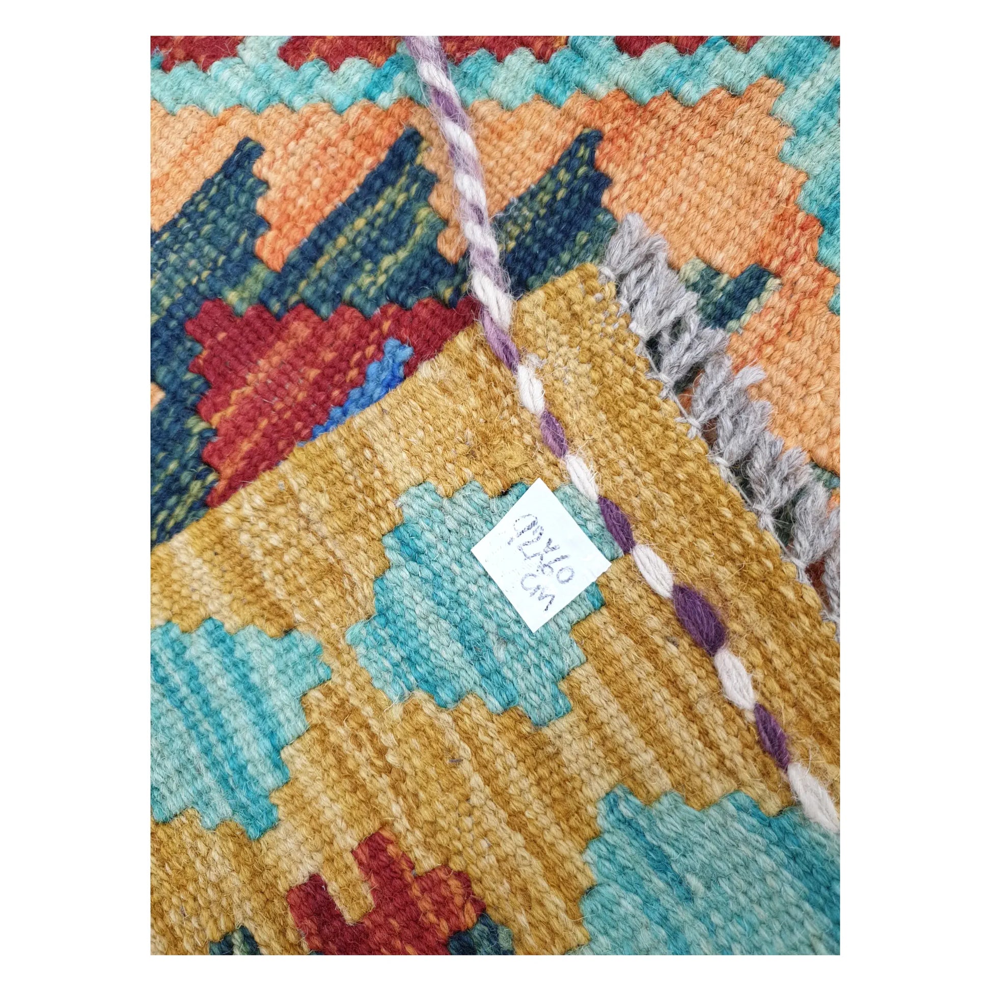 Close-up of Afghan Chobi Kilim wool flatweave texture, fringe, and geometric colour detail, 92 x 60 cm