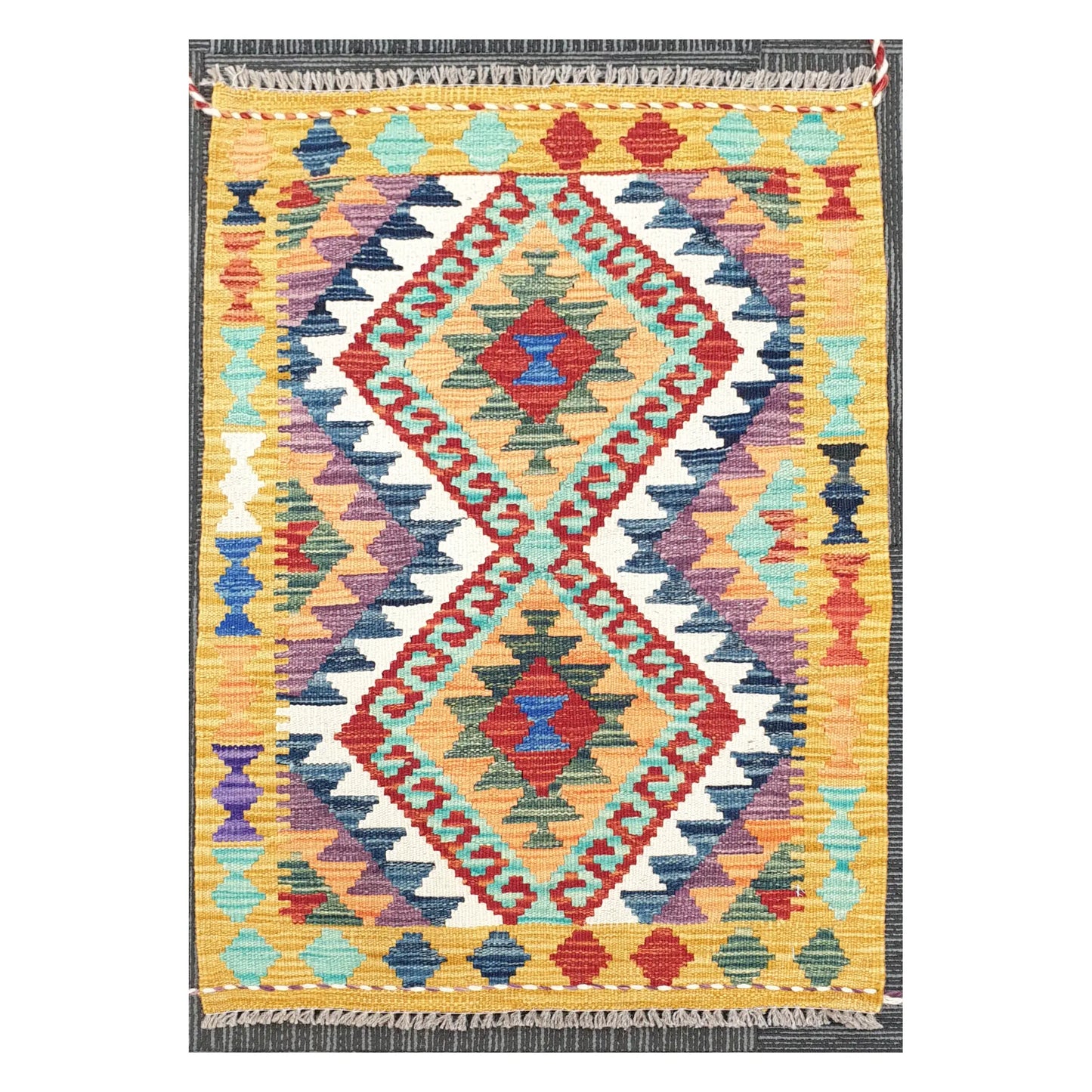 Front view of Afghan Chobi Kilim handwoven wool rug with colourful geometric pattern, 92 x 60 cm