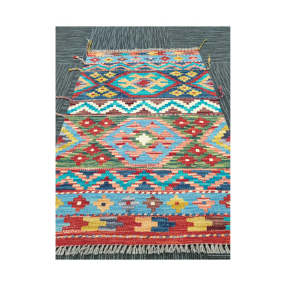 Angled view of Afghan Chobi Kilim rug showing bold geometric wool flatweave design, 96 x 62 cm
