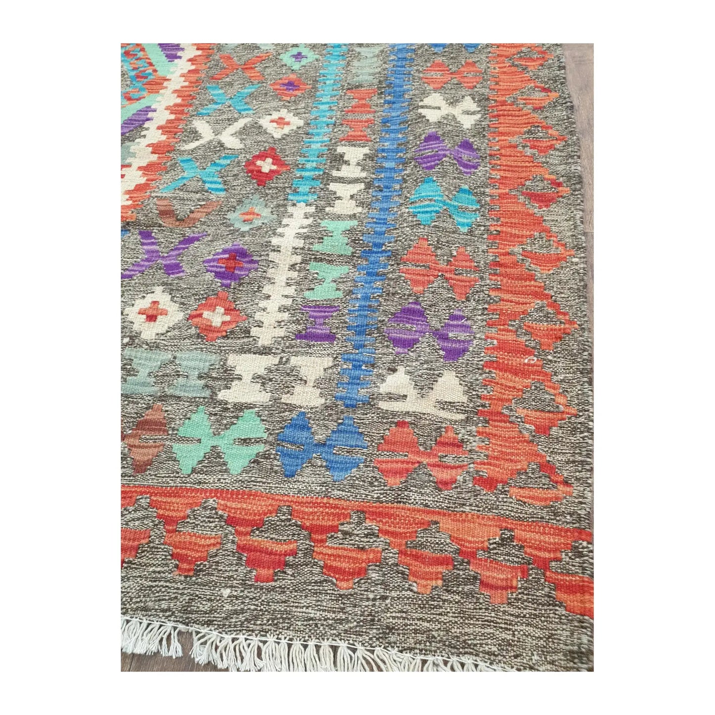 Border detail of Afghan Chobi Kilim rug showing teal, red and ivory woven motifs