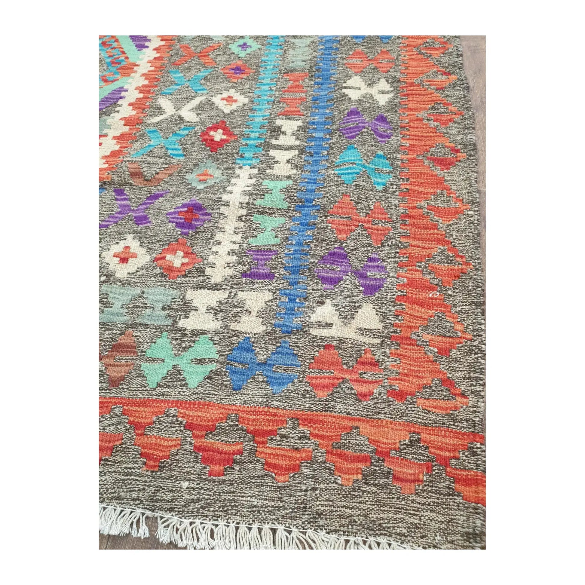 Border detail of Afghan Chobi Kilim rug showing teal, red and ivory woven motifs