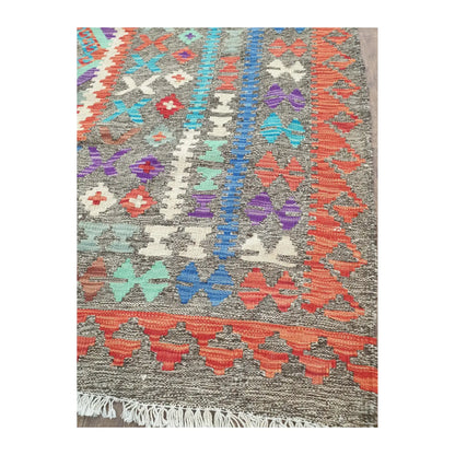 Border detail of Afghan Chobi Kilim rug showing teal, red and ivory woven motifs