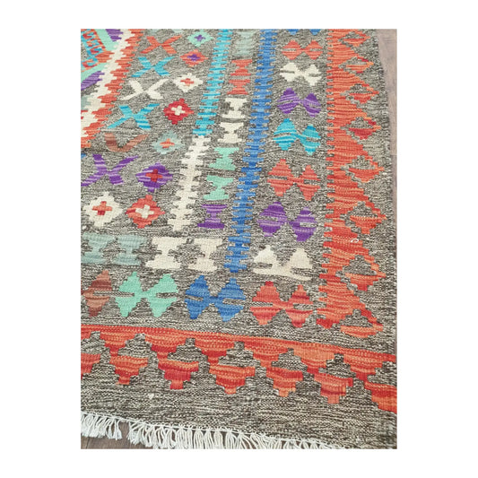 Border detail of Afghan Chobi Kilim rug showing teal, red and ivory woven motifs
