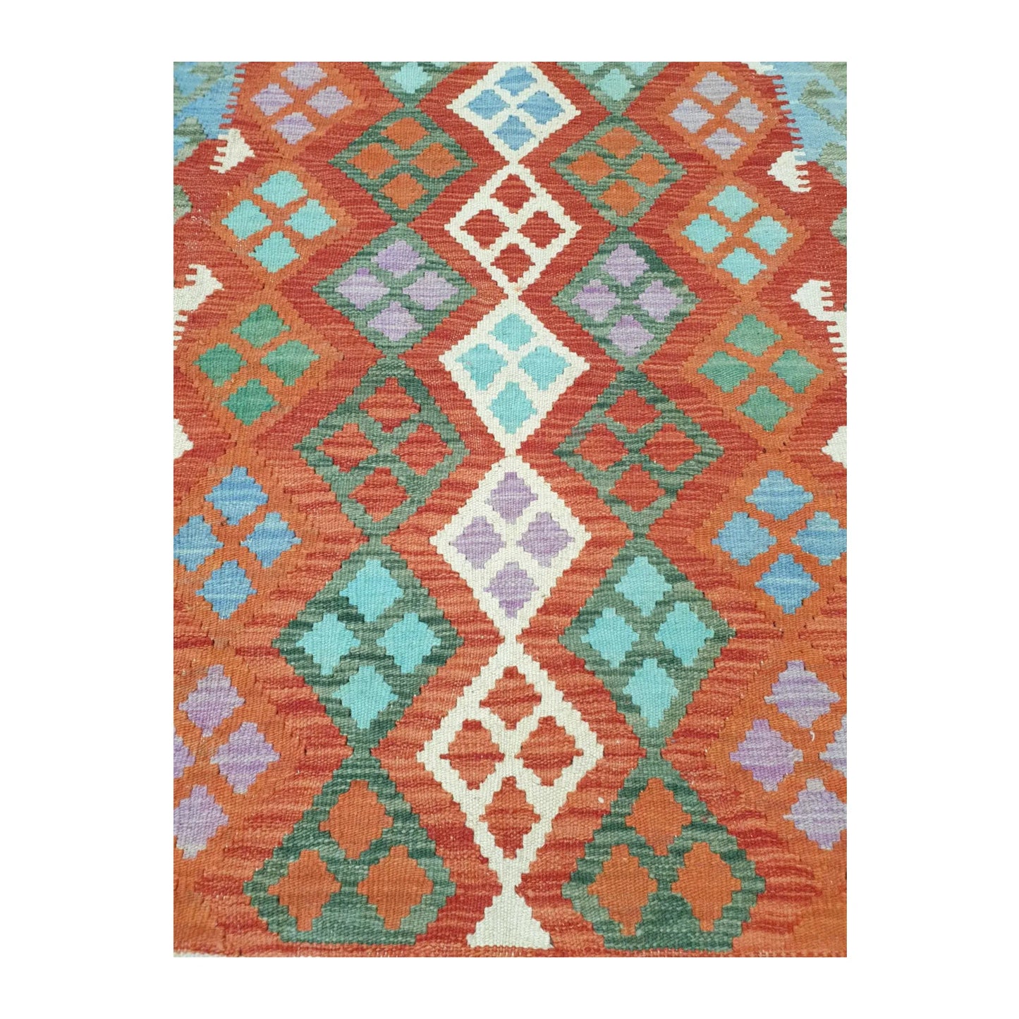 Pattern detail of Afghan Chobi Kilim hand-woven wool rug showing orange, green and ivory motifs