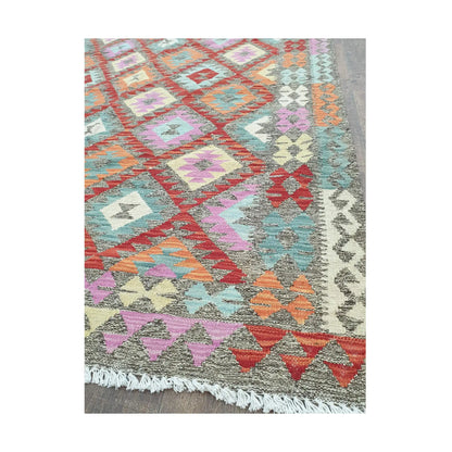Border detail of Afghan Chobi Kilim pastel diamond rug showing fringe and woven motifs