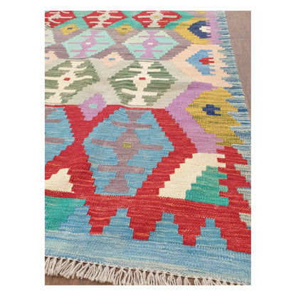 Border detail of Afghan Chobi Kilim pastel tribal rug showing fringe and woven motifs