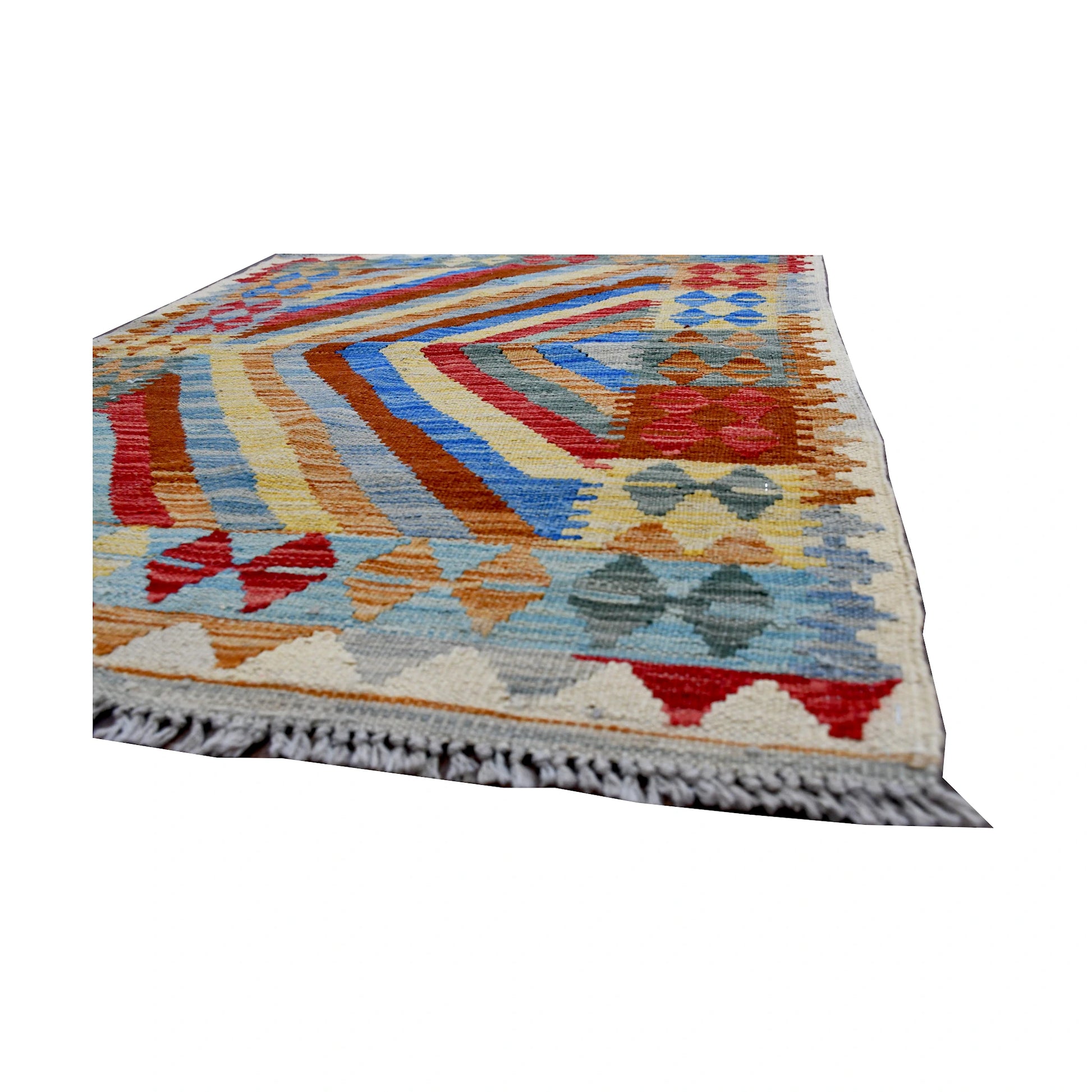 Angled edge detail of Afghan Chobi Kilim rug showing fringe, flatwoven wool texture and bold chevron pattern