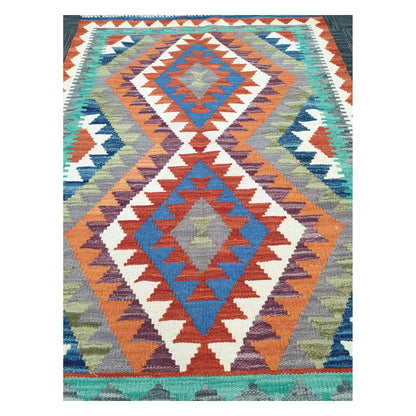 Close-up of Chobi Kilim rug with stacked medallions in terracotta, blue, teal, and ivory, 119 x 84 cm