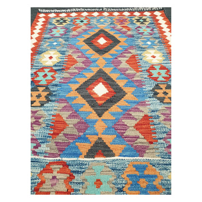Close-up of Chobi Kilim rug with stacked diamond medallions in sky blue, rust red, ivory, and lilac, 123 x 90 cm