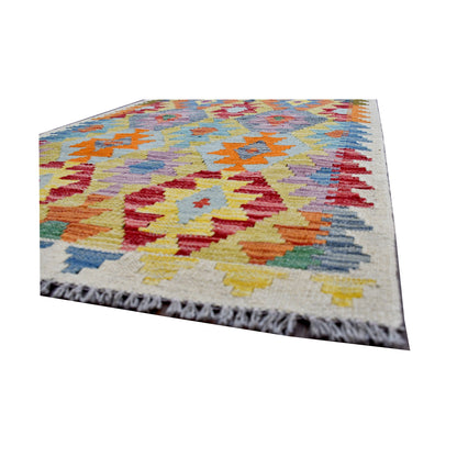 Angled fringe and edge detail of Afghan Chobi Kilim rug showing wool flatweave texture and bright pattern detail