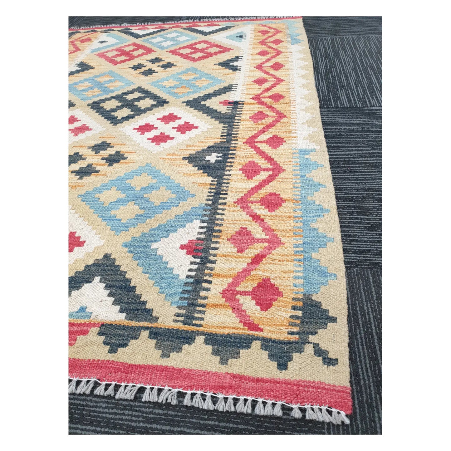 Angled detail of Afghan Chobi Kilim showing fringe, terracotta border, and flatweave geometric pattern, 144 x 100 cm