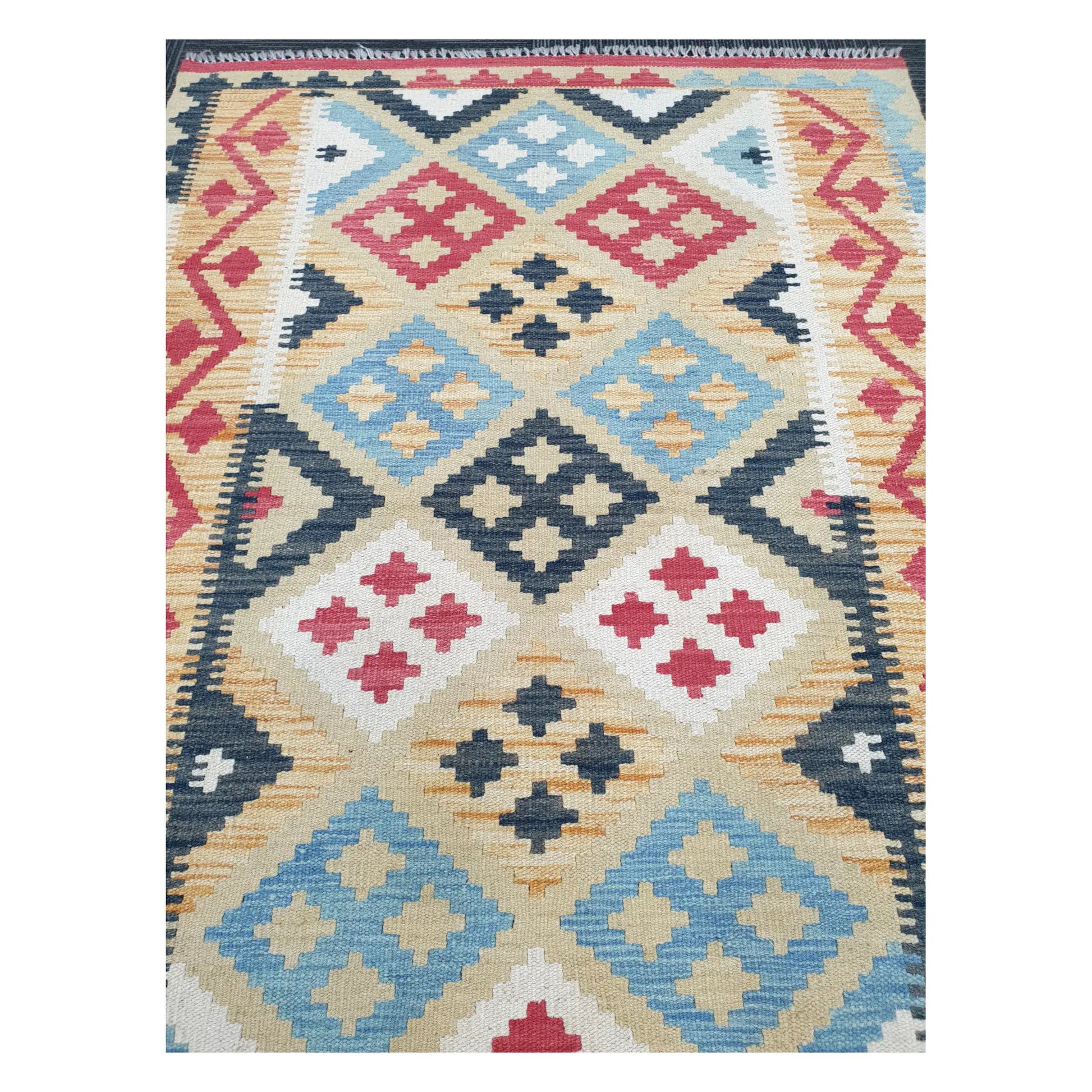 Close-up of Chobi Kilim rug with blue, charcoal, and ivory diamond motifs with tribal accents, 144 x 100 cm