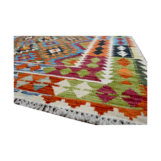 Angled fringe and edge detail of Afghan Chobi Kilim rug showing wool flatweave texture with orange, green, burgundy and ivory motifs
