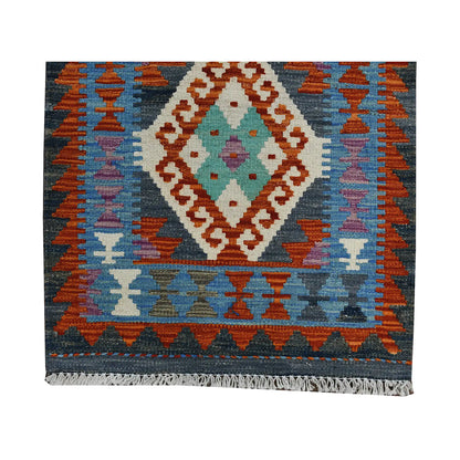 End border detail of Afghan Chobi Kilim runner with blue field, rust accents and central diamond motif