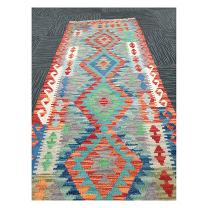 Close runner view of Afghan Chobi Kilim handwoven flatweave with elongated linked medallion design, 207 x 65 cm