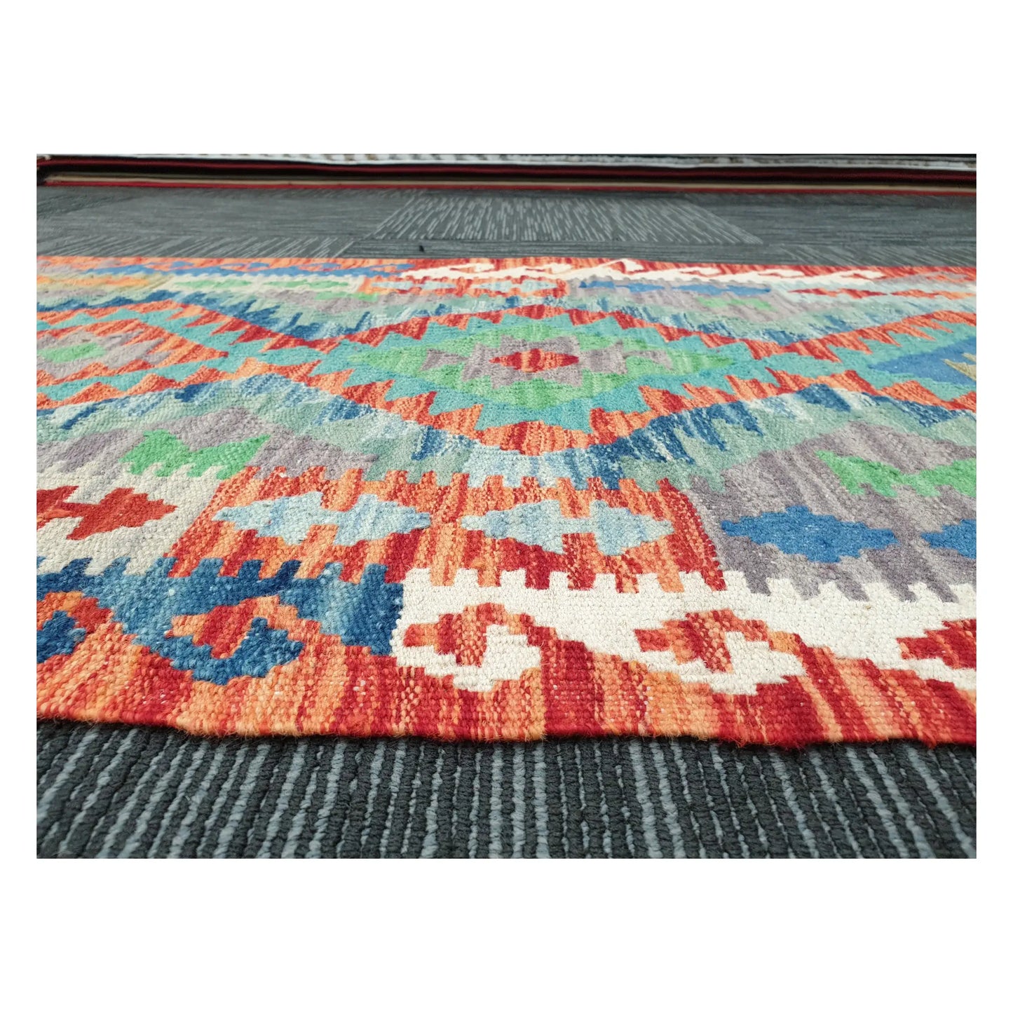 Low-angle close-up of Afghan Chobi Kilim wool flatweave texture and geometric pattern detail, 207 x 65 cm