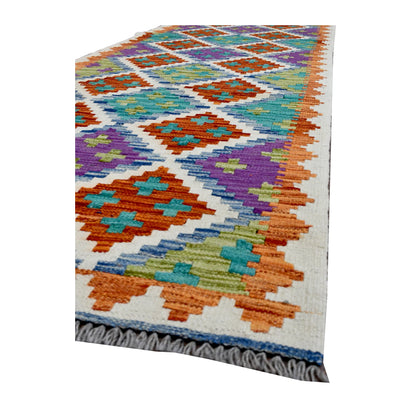 Angled corner of Afghan Chobi Kilim runner showing stepped diamond motifs, zigzag edging and grey fringe