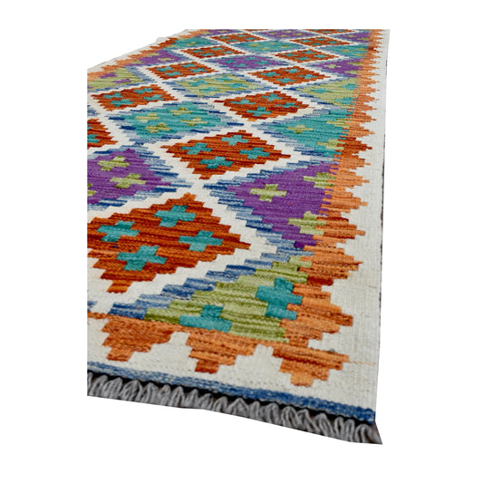 Angled corner of Afghan Chobi Kilim runner showing stepped diamond motifs, zigzag edging and grey fringe