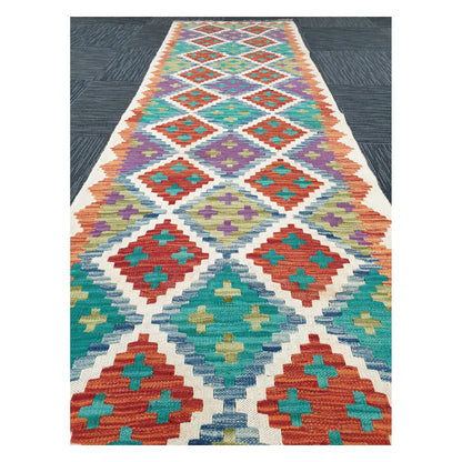 Close runner view of Afghan Chobi Kilim handwoven flatweave with ivory diamond trellis design, 286 x 77 cm
