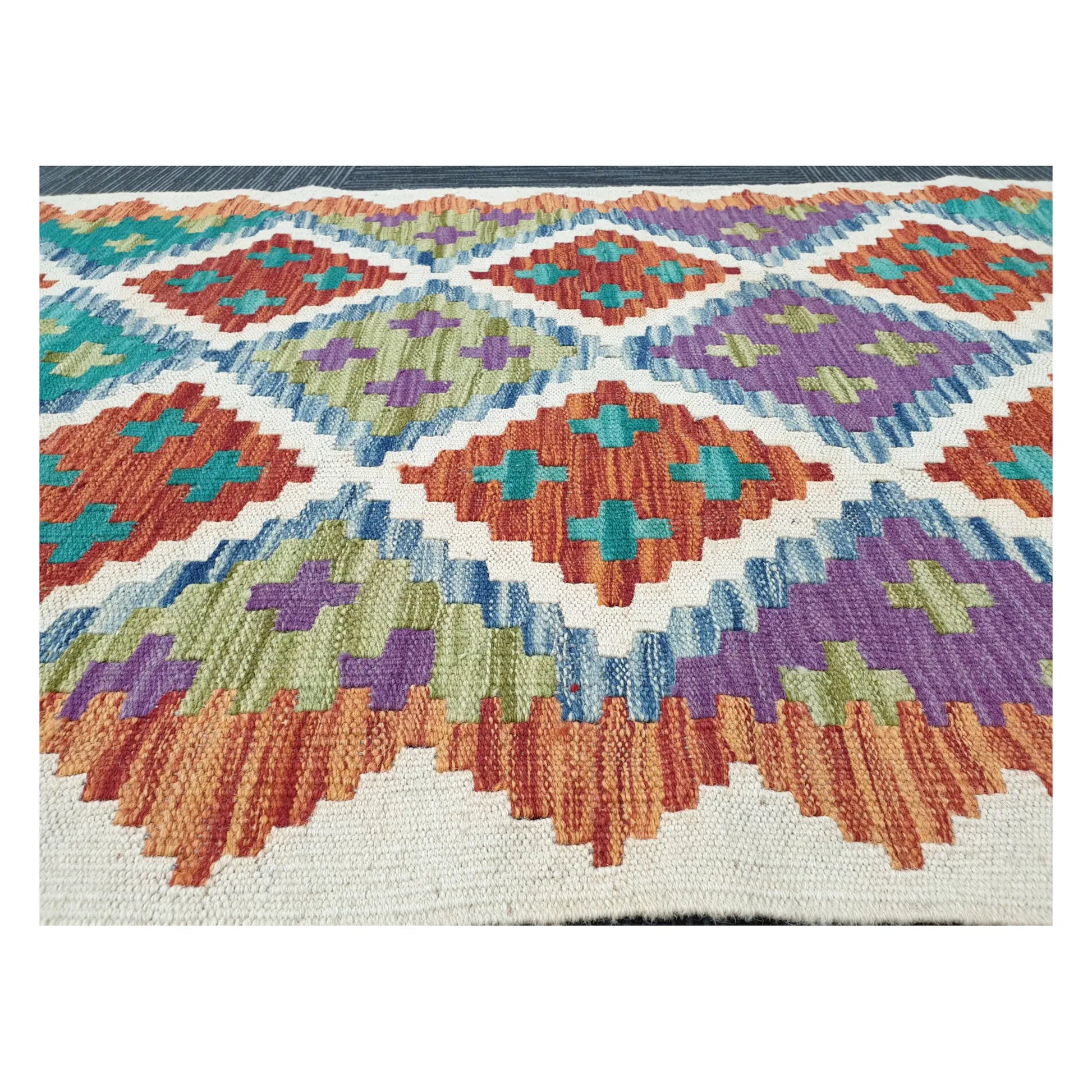 Low-angle close-up of Afghan Chobi Kilim wool flatweave texture and geometric pattern detail, 286 x 77 cm