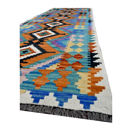 Angled full view of Afghan Chobi Kilim runner showing its linked diamond spine, stepped side motifs and grey fringe