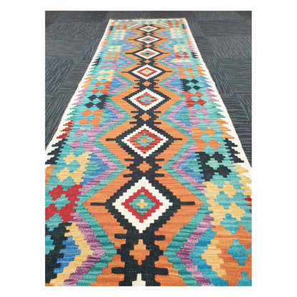 Close runner view of Afghan Chobi Kilim handwoven flatweave with linked diamond chain pattern, 291 x 80 cm