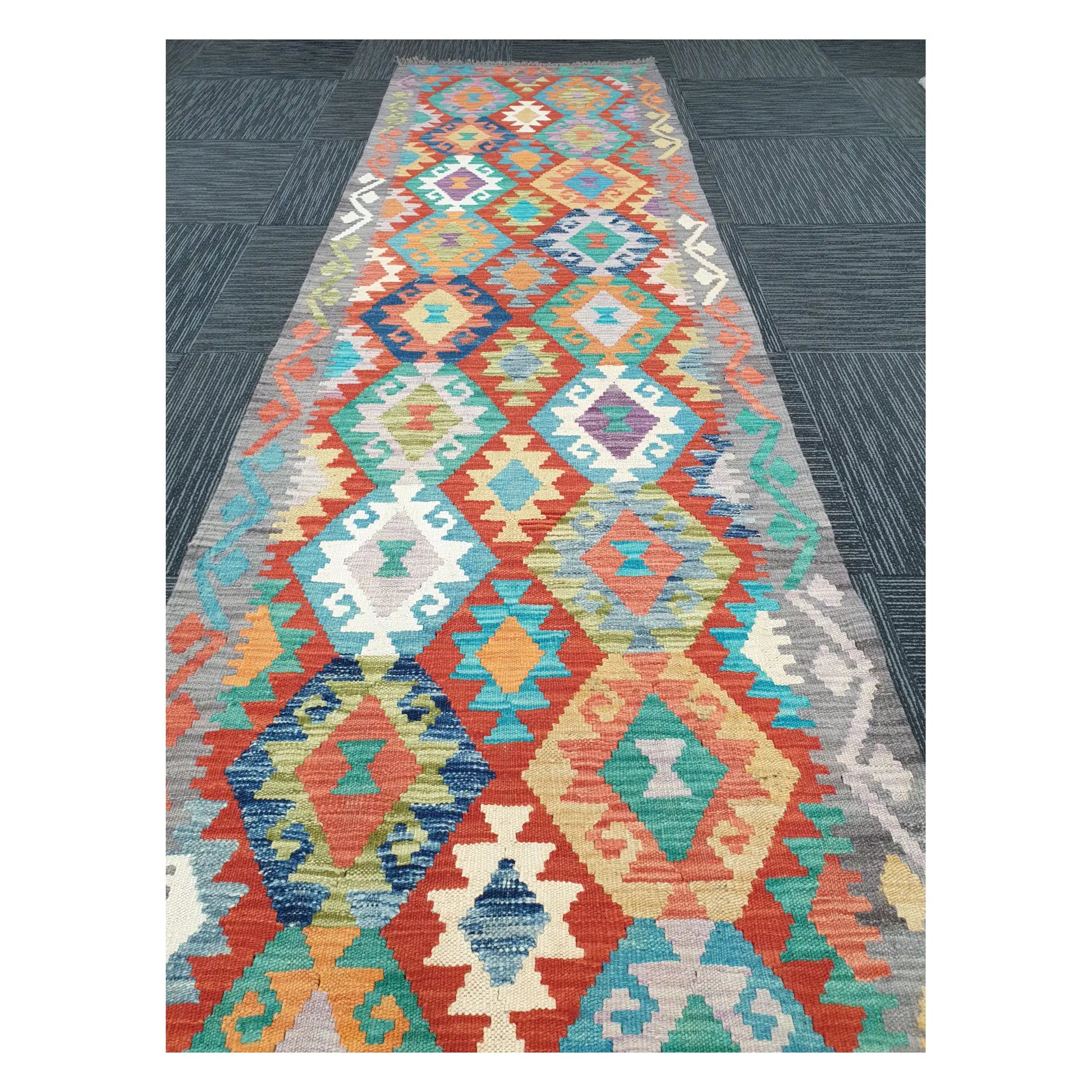 Close runner view of Afghan Chobi Kilim handwoven flatweave with pastel diamond chain design, 291 x 81 cm