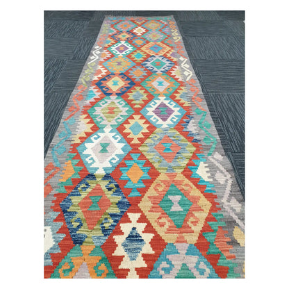 Close runner view of Afghan Chobi Kilim handwoven flatweave with pastel diamond chain design, 291 x 81 cm