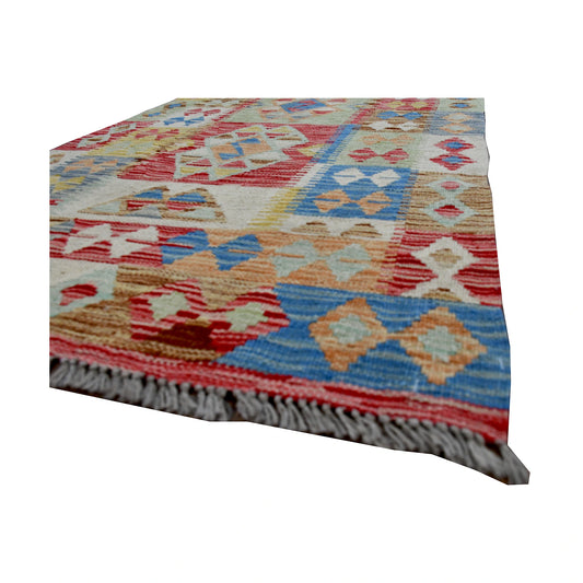Angled fringe and edge detail of Afghan Chobi Kilim runner showing wool flatweave texture and pastel geometric motifs