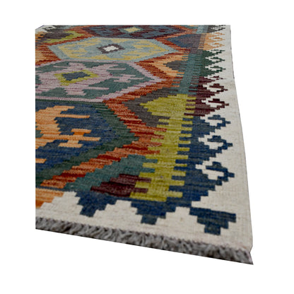 Angled edge and fringe detail of Afghan Chobi Kilim runner showing wool flatweave texture and stepped border