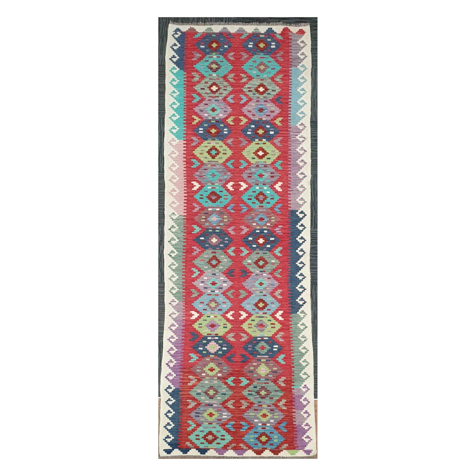 Full view of Afghan Chobi Kilim handwoven wool runner with coral medallion chain design, 386 x 79 cm