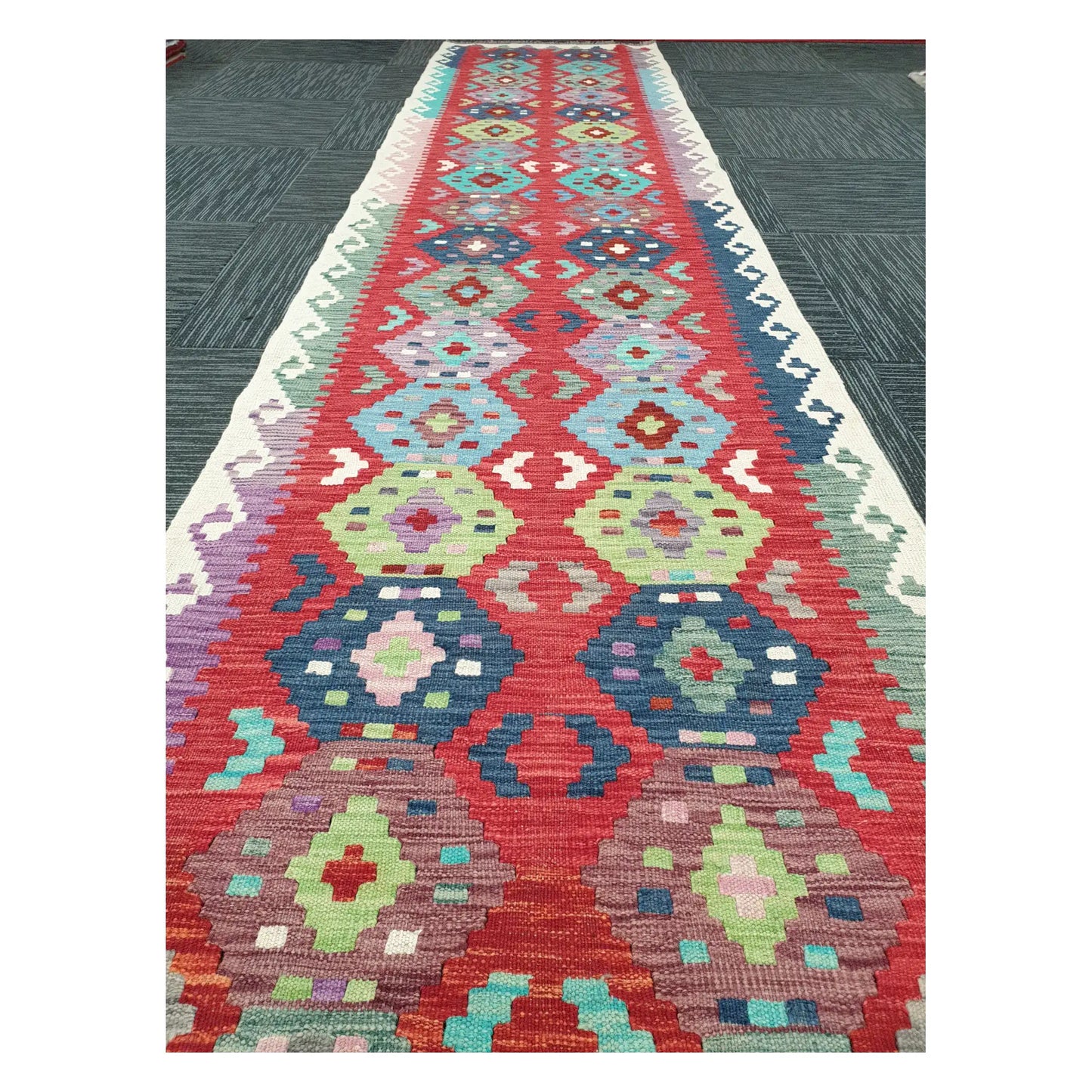 Close runner view of Afghan Chobi Kilim handwoven flatweave with repeating medallion chain design, 386 x 79 cm