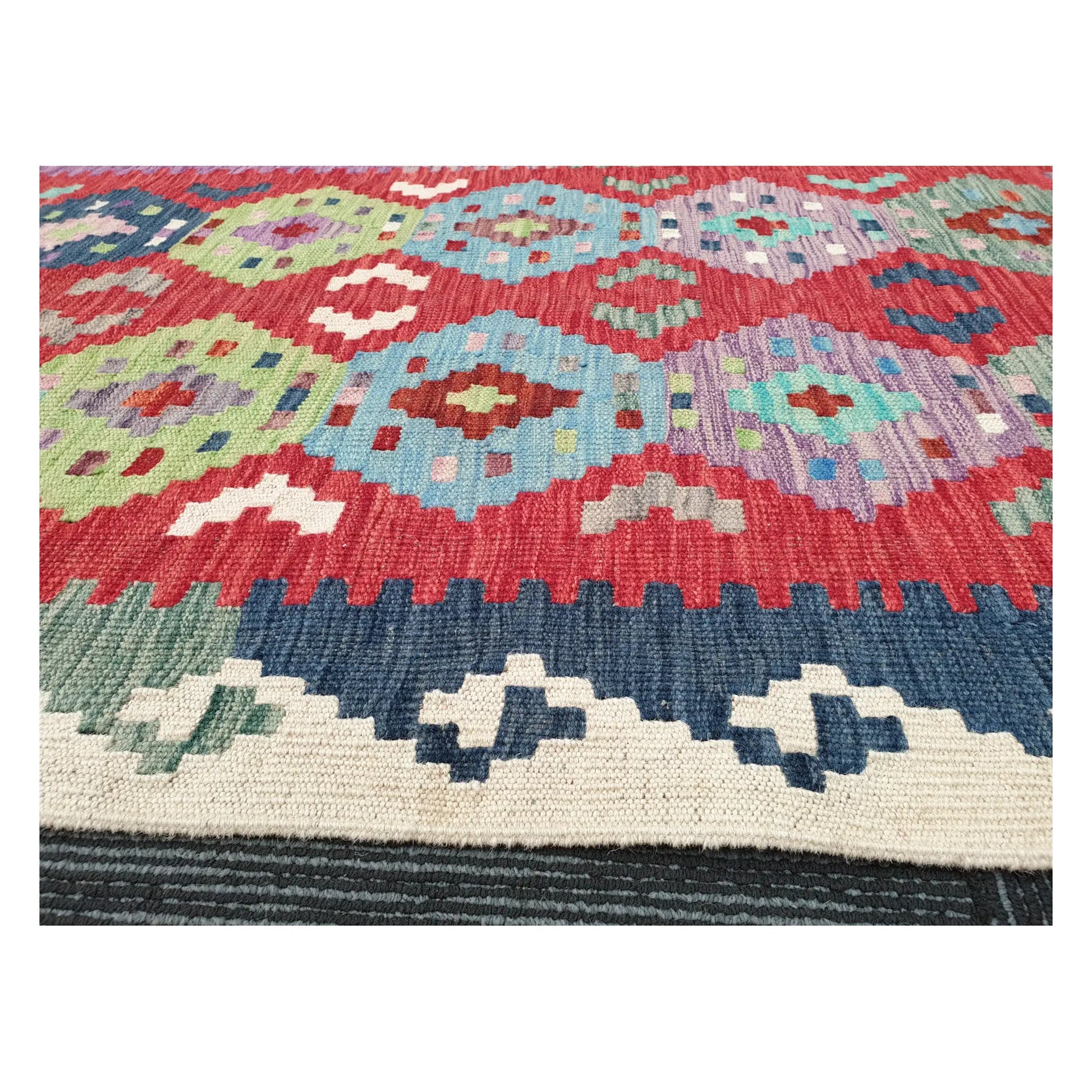 Low-angle close-up of Afghan Chobi Kilim wool flatweave texture and geometric pattern detail, 386 x 79 cm
