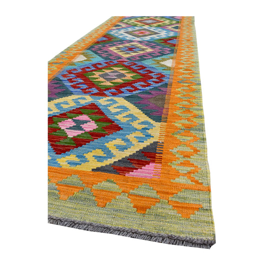 Angled corner detail of Afghan Chobi Kilim runner showing the orange linked border, triangular end band and multicoloured field