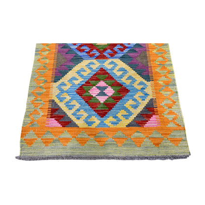 End detail of Afghan Chobi Kilim runner showing a large diamond medallion with a sky-blue stepped outline, orange-and-ochre border and grey fringe