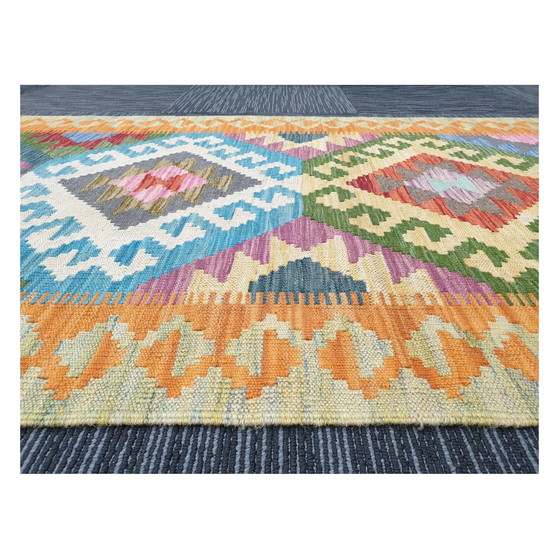 Low-angle close-up of Afghan Chobi Kilim wool flatweave texture and geometric pattern detail, 386 x 86 cm