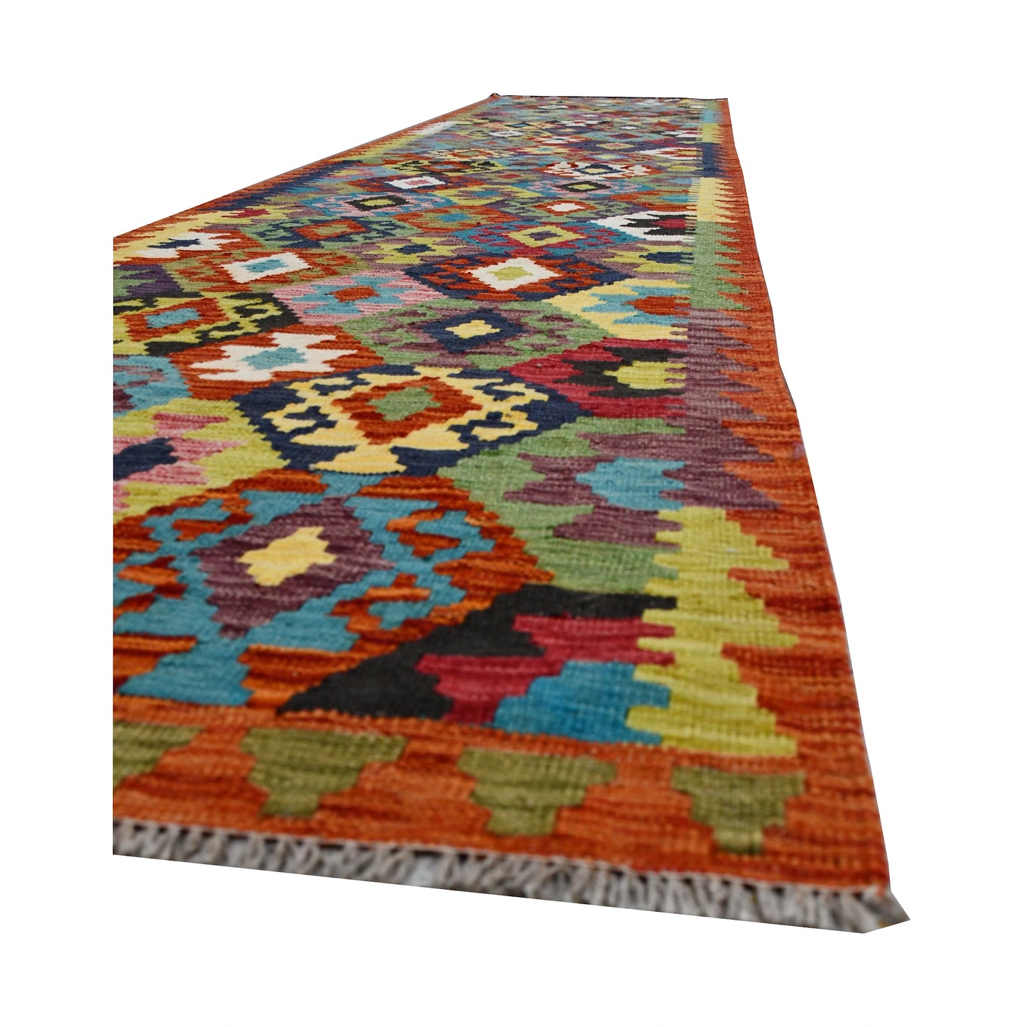 Angled edge and fringe detail of Afghan Chobi Kilim runner showing wool flatweave texture and bright geometric motifs