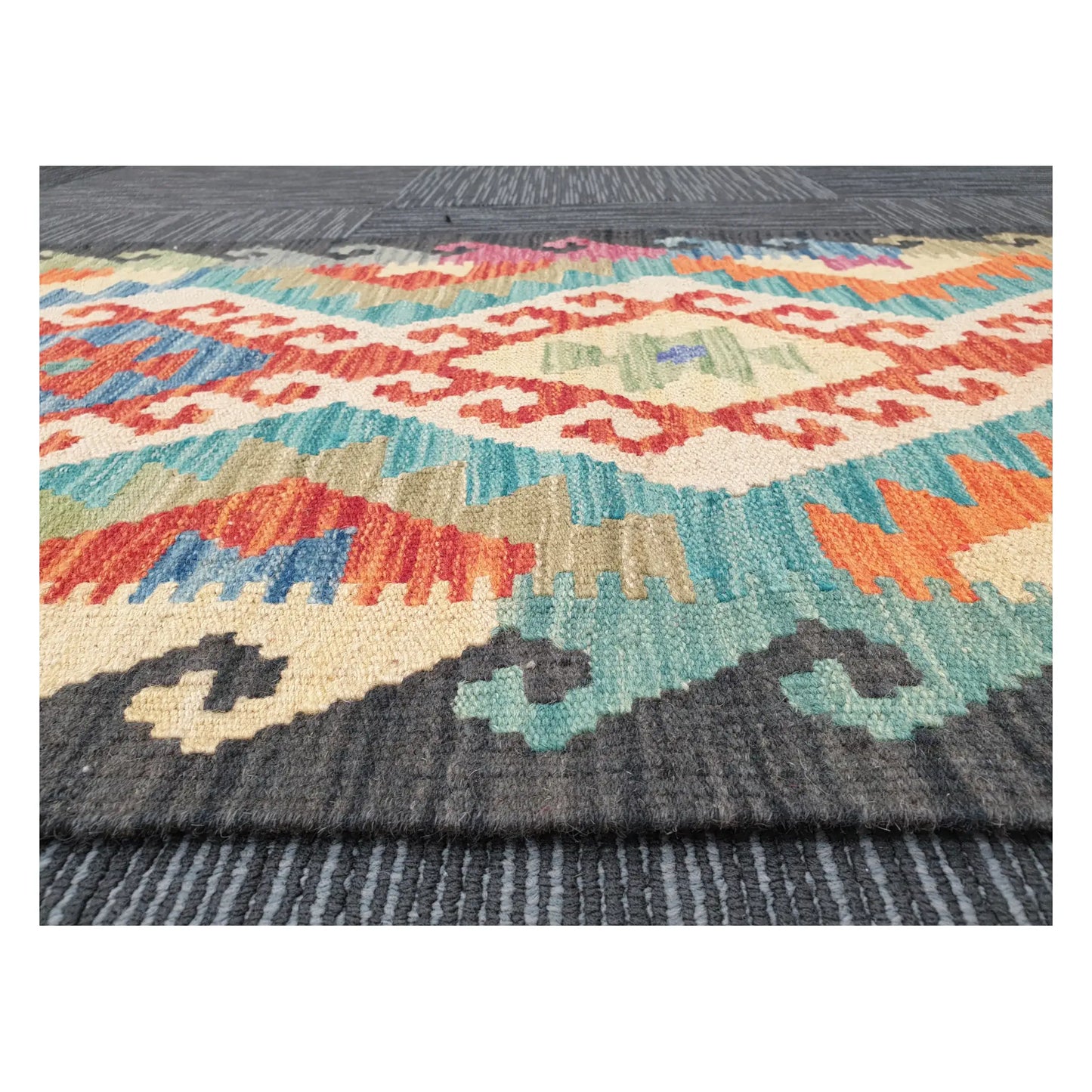 Low-angle close-up of Afghan Chobi Kilim wool flatweave texture and geometric border detail, 194 x 63 cm