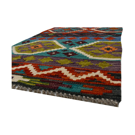 Angled fringe and flatweave detail of Afghan Chobi Kilim wool rug showing teal, rust, olive and burgundy geometric pattern
